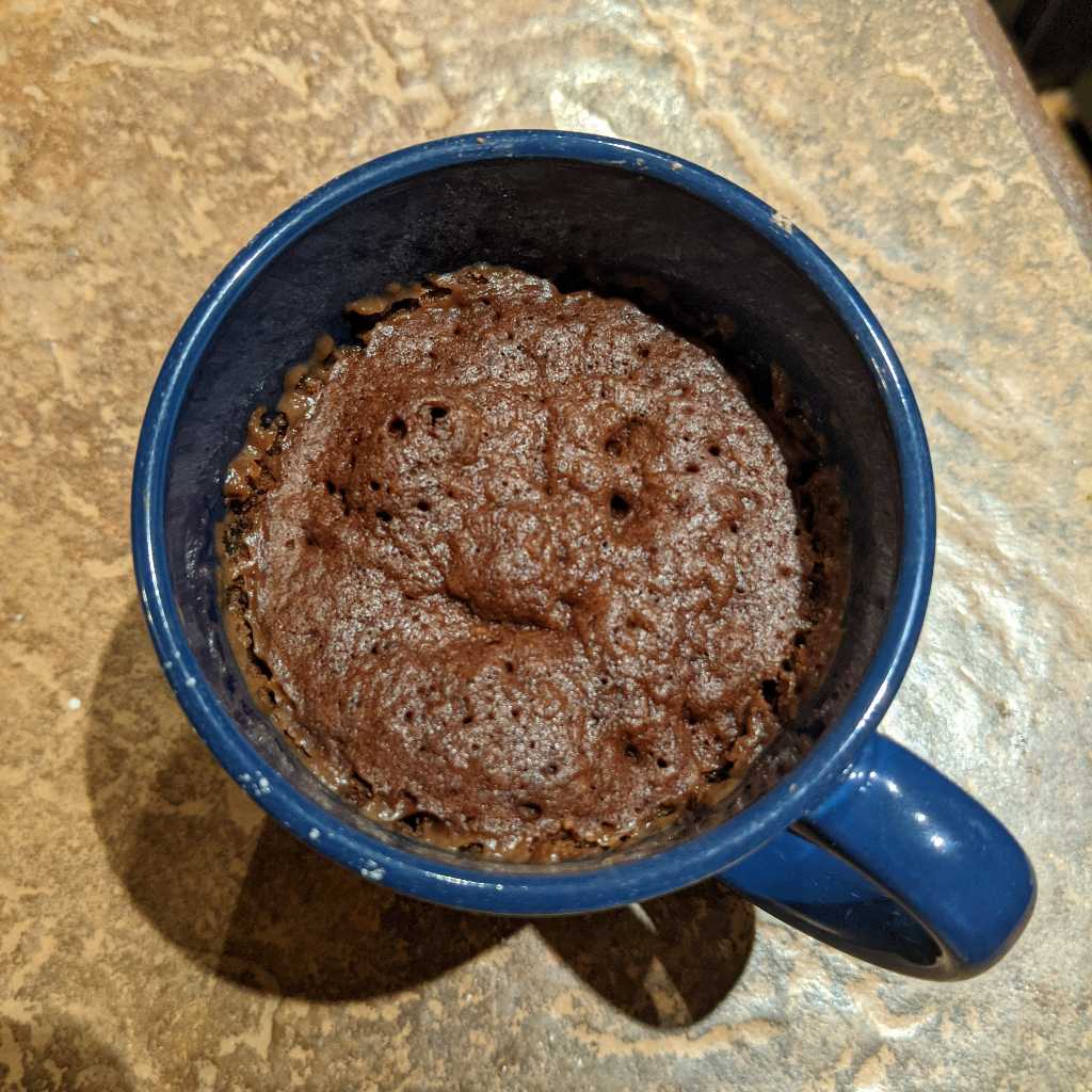 Chocolate mug cake after it's been cooked for a minute