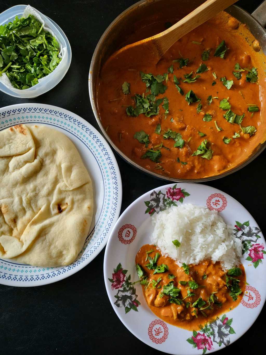 Chicken tikka masala, rice, naan, and a side of cilantro