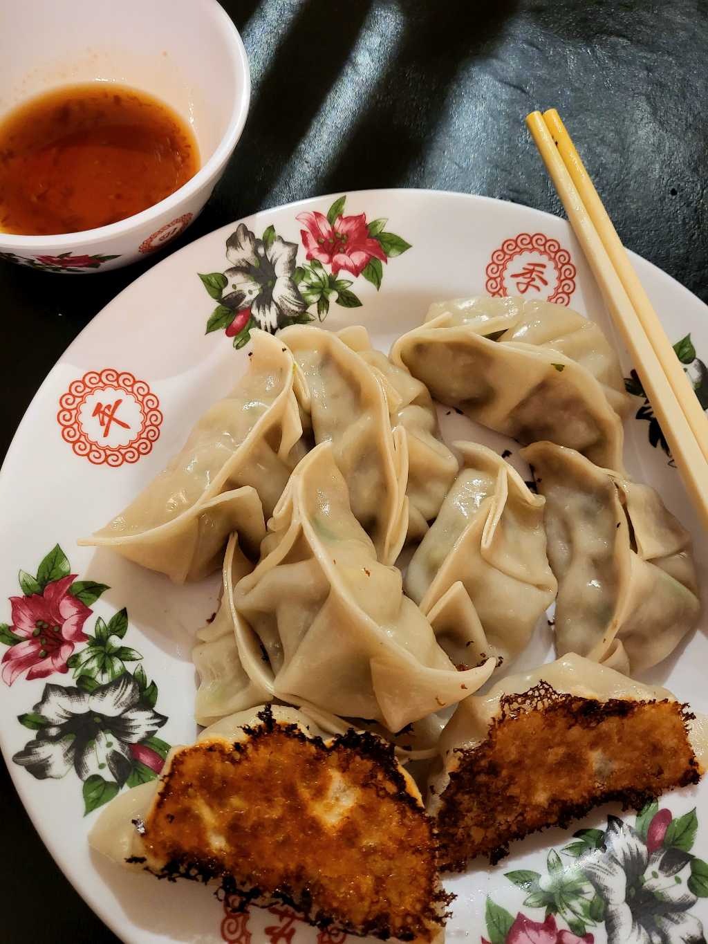 Some cooked dumplings and dipping sauce