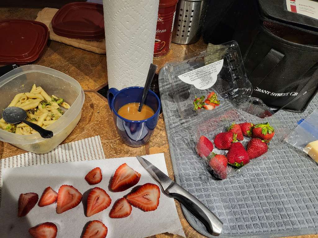 Some coffee, some pasta to pack for lunch, and some cut up strawberries as well