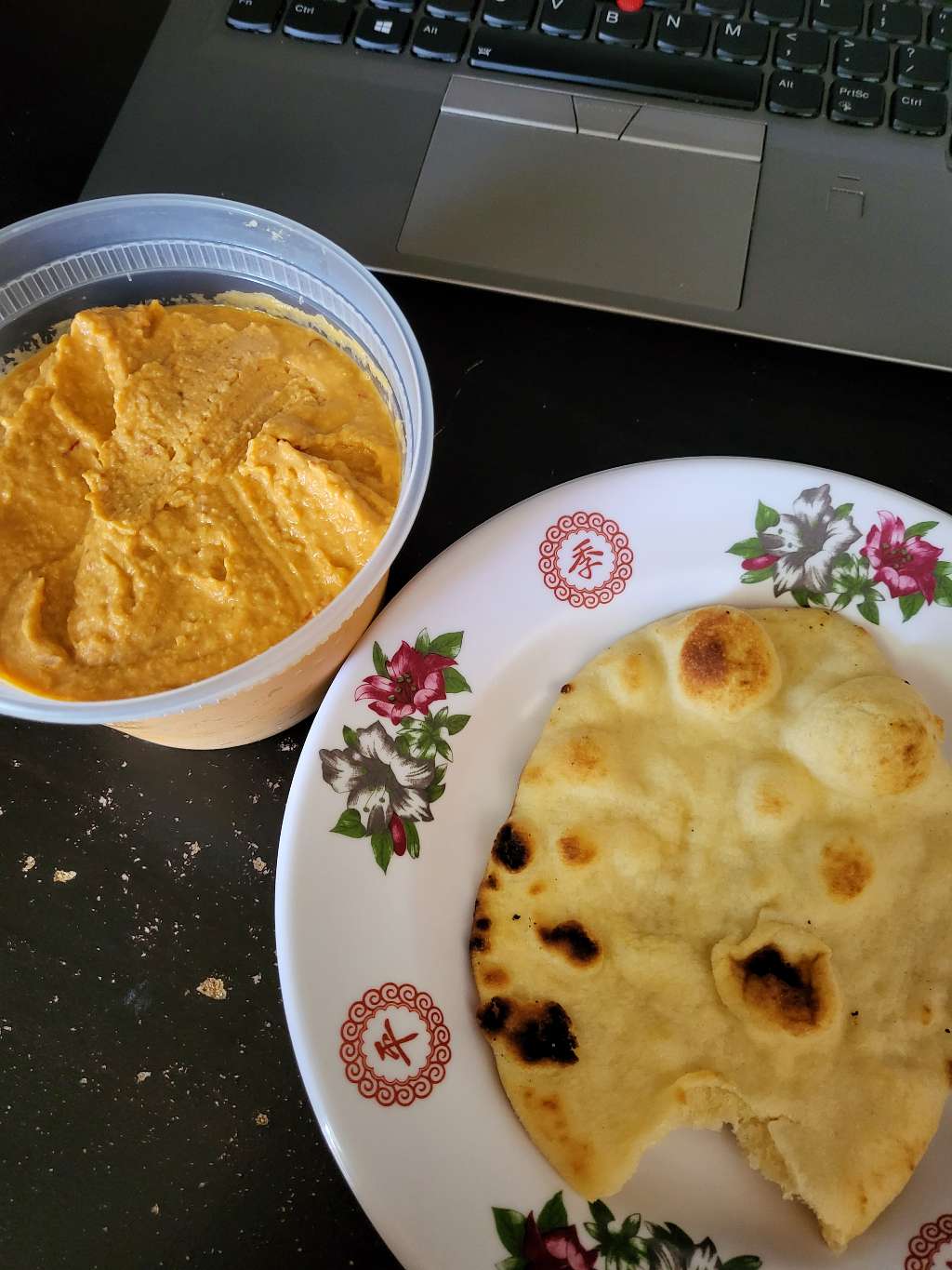 Hummus with a piece of naan bread