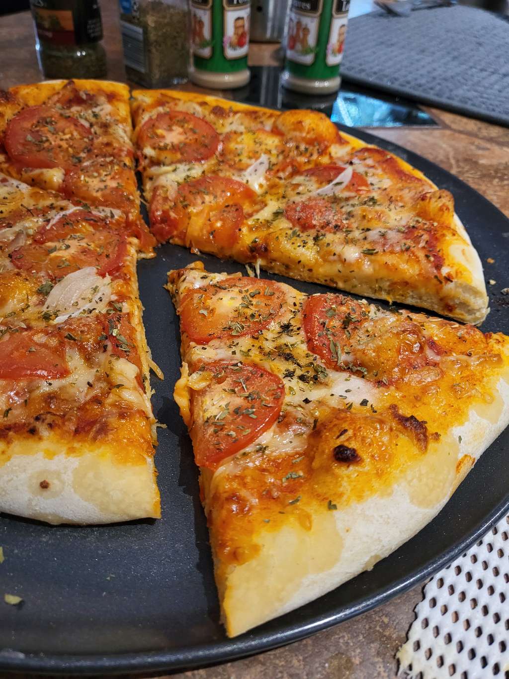 Sliced pizza, with one piece sticking out a little more than the others