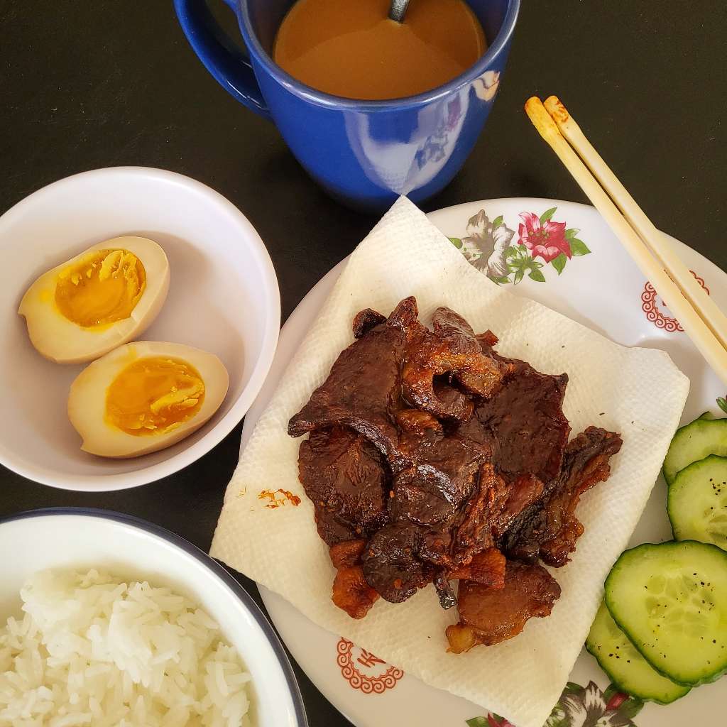 Coffee and rice with beef jerky, a soft boiled egg, and some cucumbers