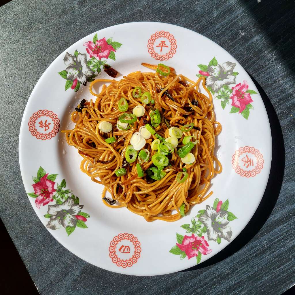 Scallion oil noodles with more scallions garnished on top