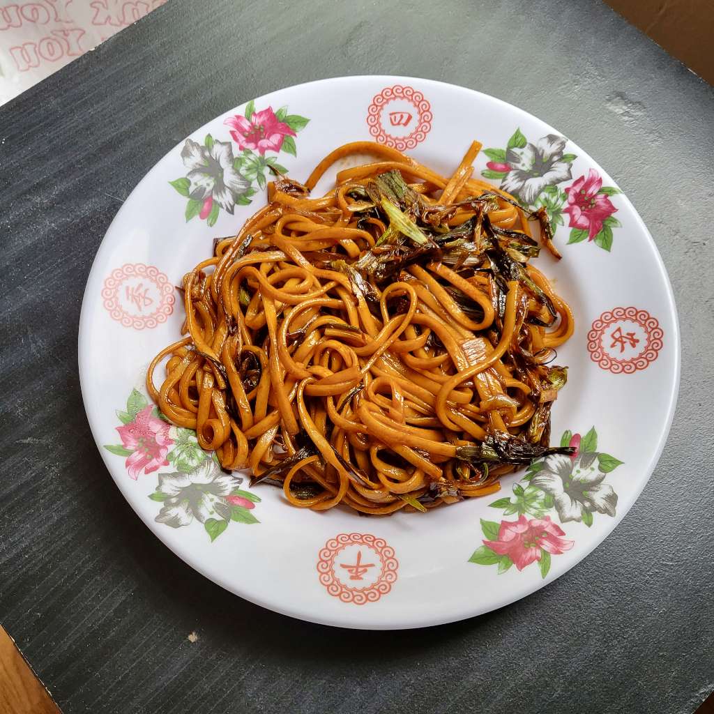 Another plate of stir fried noodles with crispy scallions on top