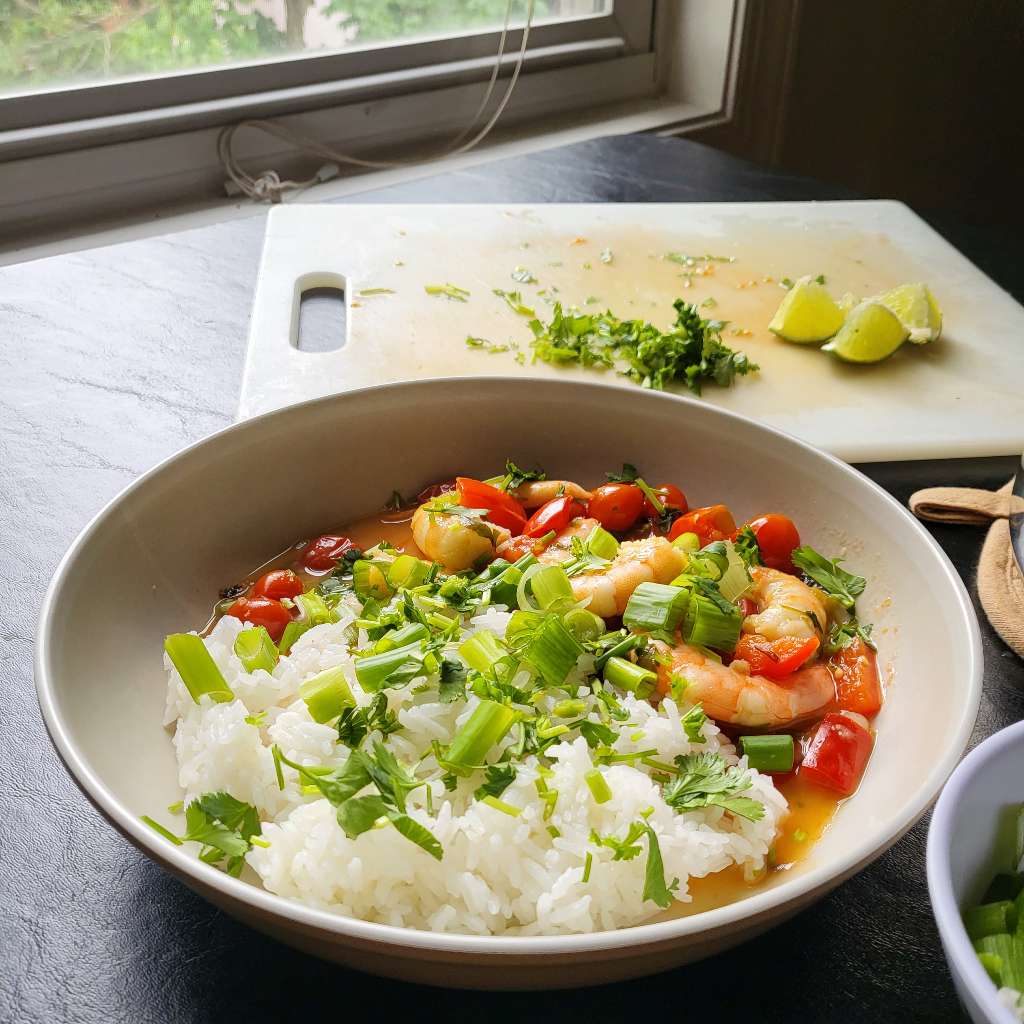 A different angle of the bowl of rice and shrimp. You can see the window in the background