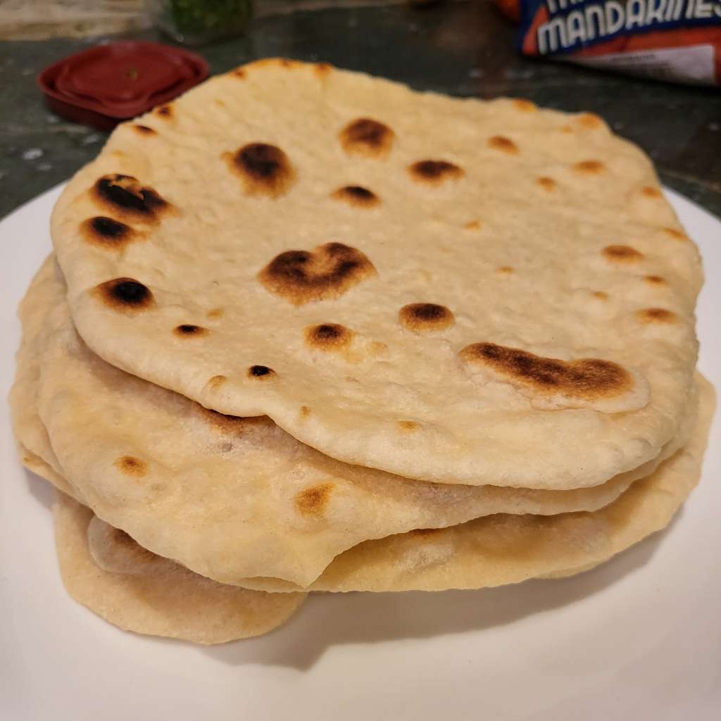 A stack of some naan on a plate