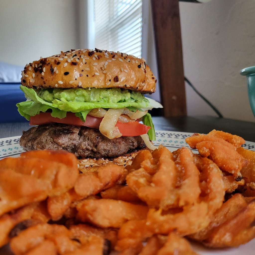 The same burger and fries, taken at a different angle, with the fries sitting up front