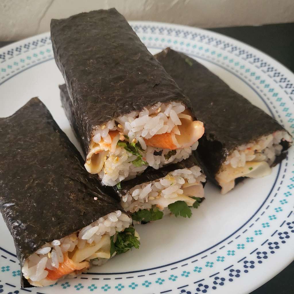 A top view of the four musubis sitting on a plate