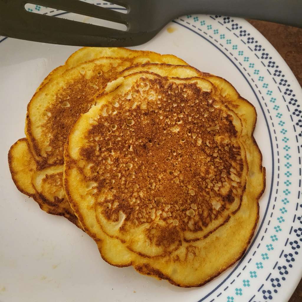 Two ricotta pancakes stacked on top of each other