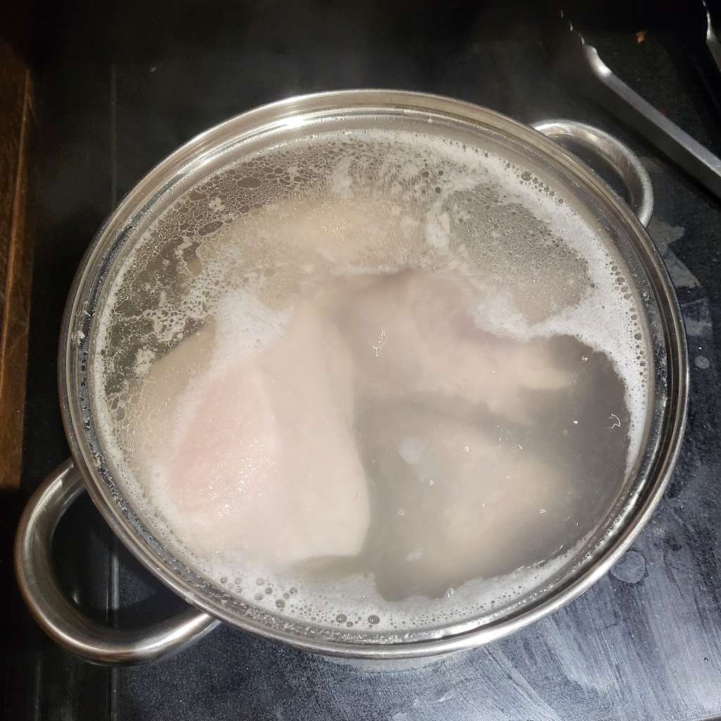 The pieces of pork, simmering in the pot
