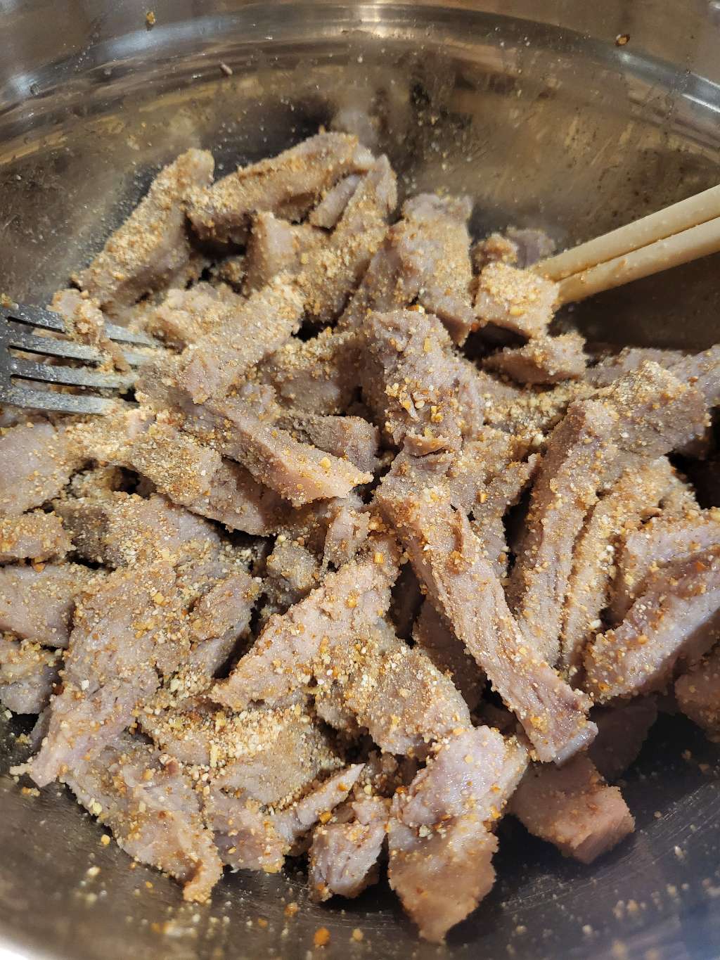 The cooked, sliced pork with seasonings on it