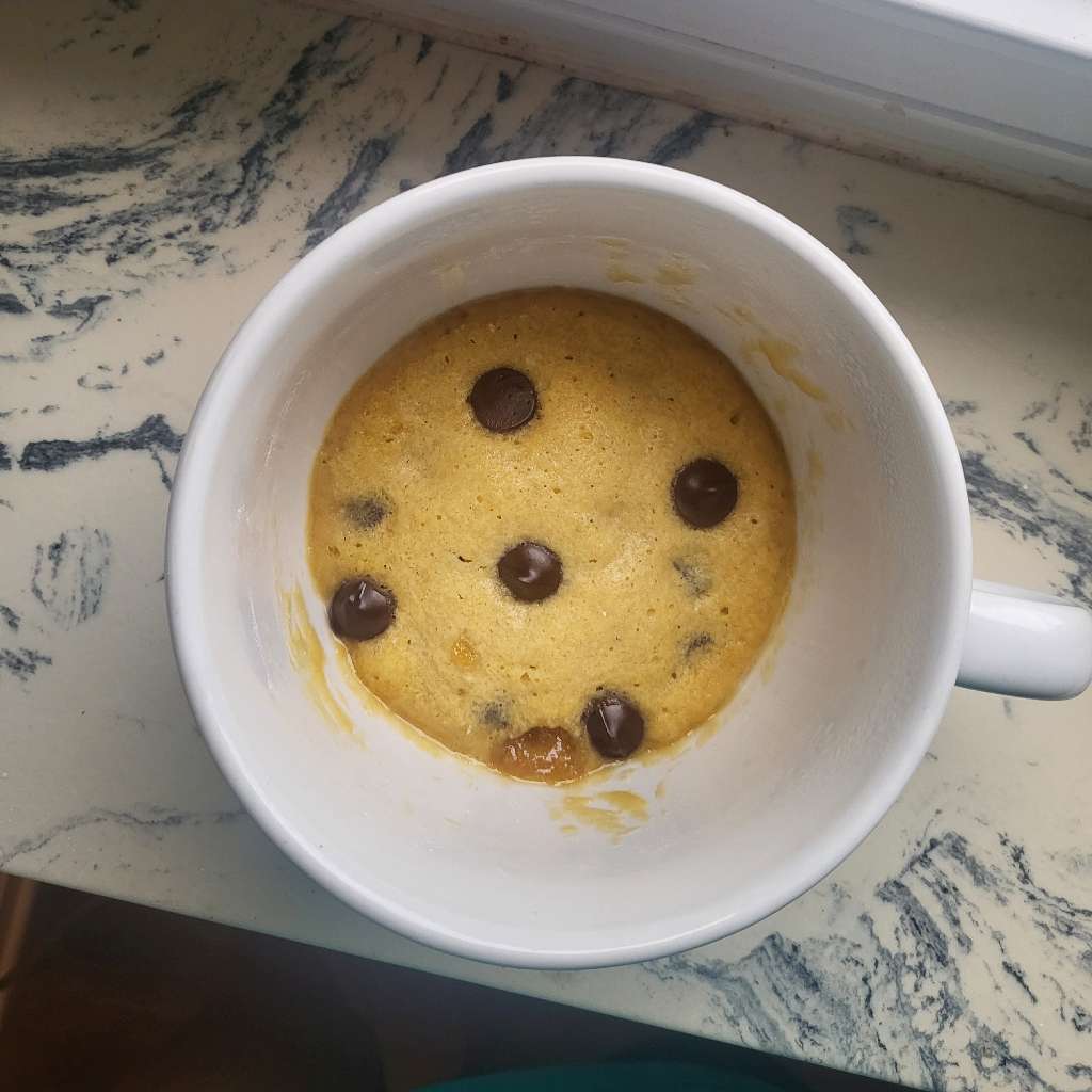 A chocolate chip cookie in a very large mug