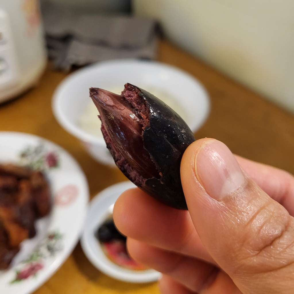 Me holding up an olive that I took a bite of. You can see the pit.