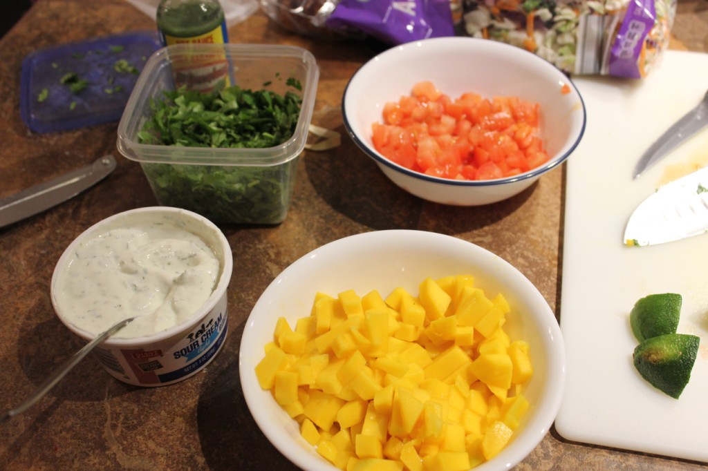 Diced tomatoes, diced mangoes, cilantro, and lime crema