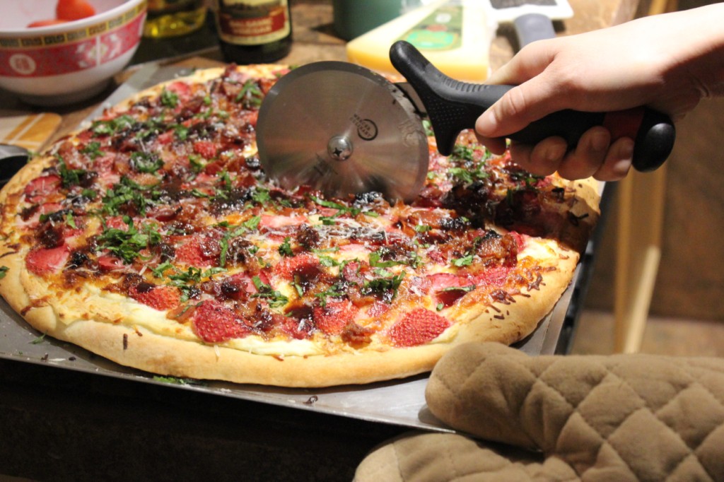 Cutting up the strawberry pizza