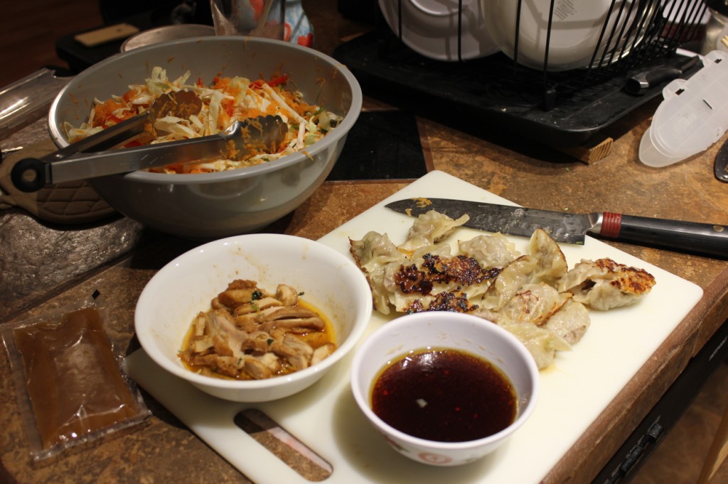 Preparing dumplings and salad with chicken